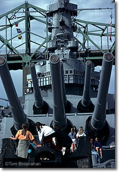 Visitors examine the cannons on the USS Massachusetts battleship