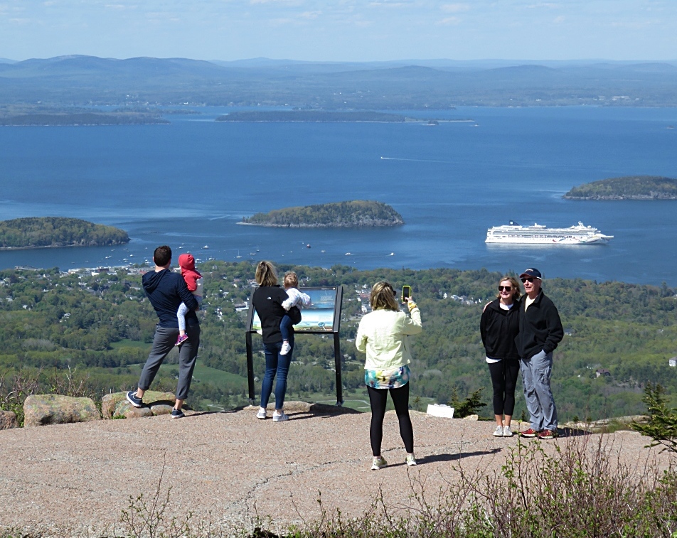 Visitors atop Cadillac Mountain overlooking Bar Harbor, Maine